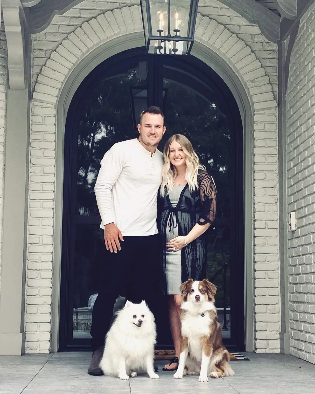 Mike and Jessica with their two dogs at home 