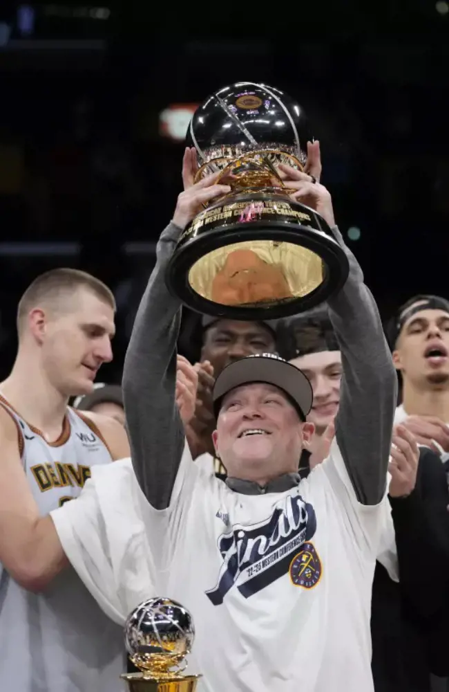 Head coach Michael Malone holding the conference championship trophy.