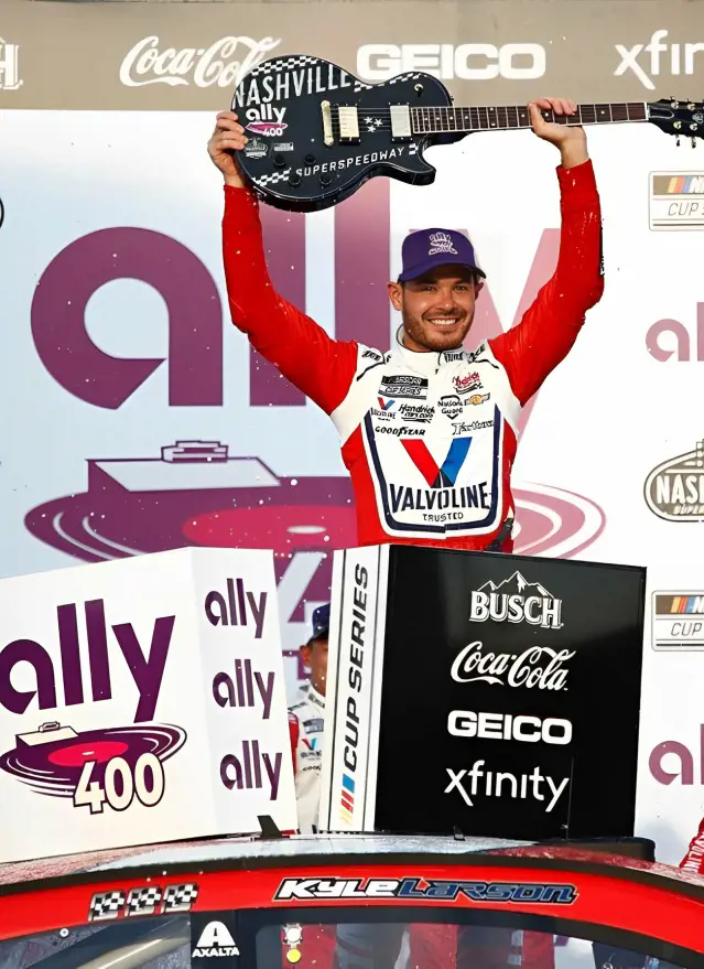 Kyle Larson raising guitar after winning the 2020 Ally 400.