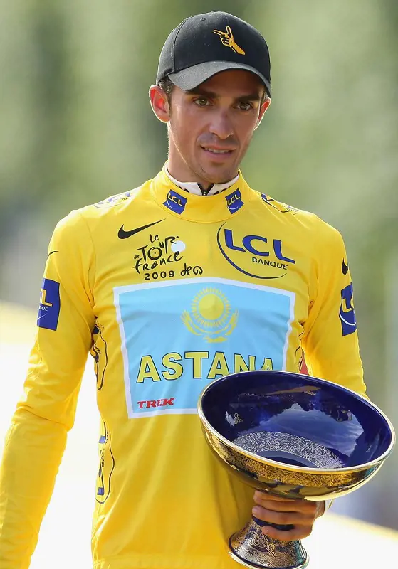 Alberto holds his 2009 Tour de France trophy wearing Yellow Jersey.