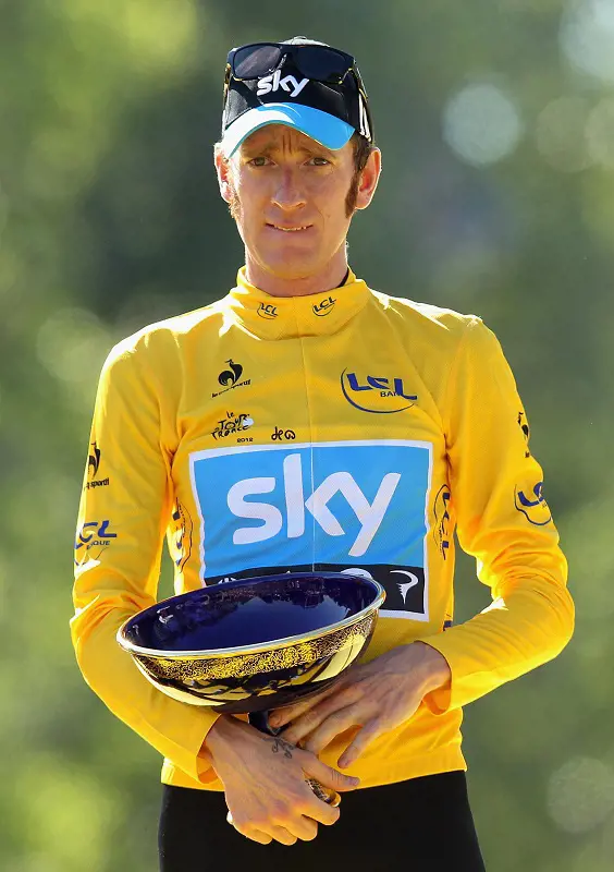 Bradley Wiggins carries his 2012 Tour de France trophy.