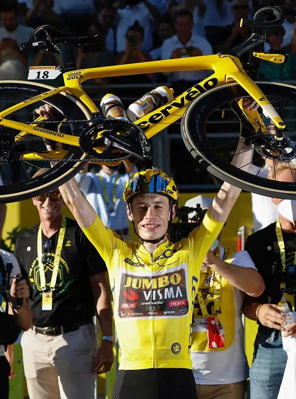 Jonas carries his bicycle after securing first position in 2022