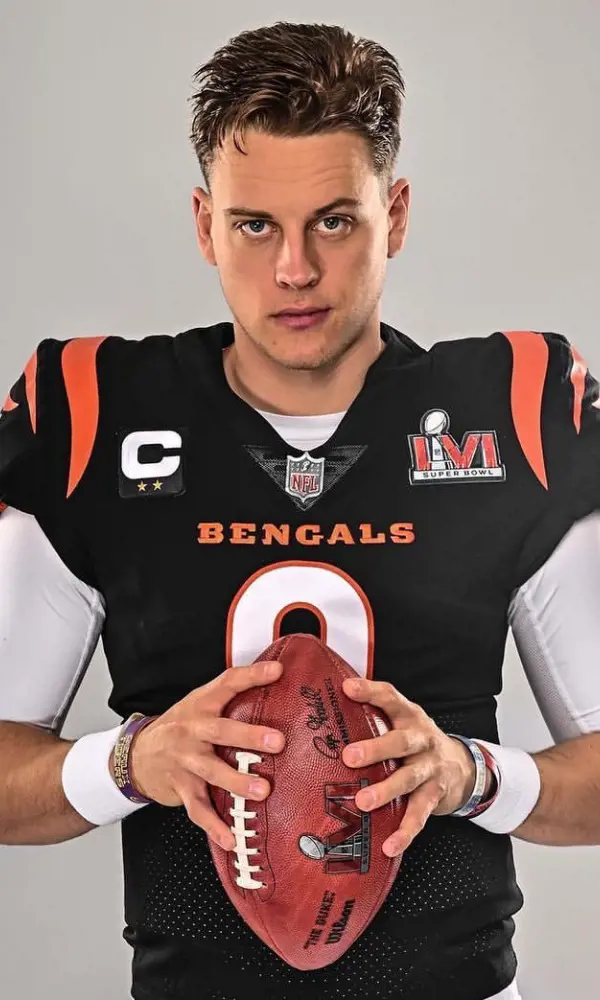 Joe posing for the picture wearing Cincinnati Bengals jersey. 