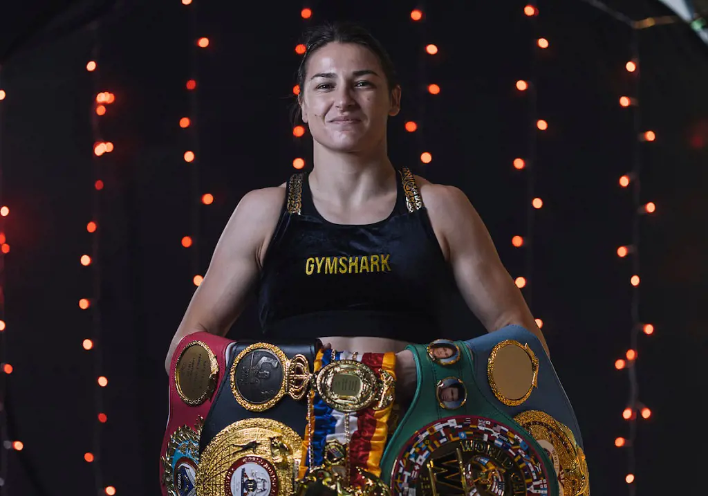 Katie showing off her championship belt wearing the Gymshark apparel.