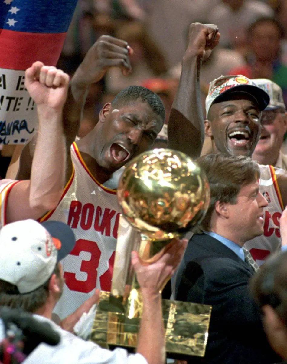 Houston Rockets players celebrating their consecutive NBA title after defeating the Orlando Magic in the 1995 Finals