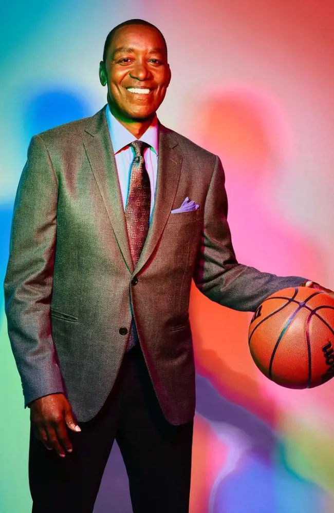 Isiah donning a dashing look in a grey suit pant in 2022.