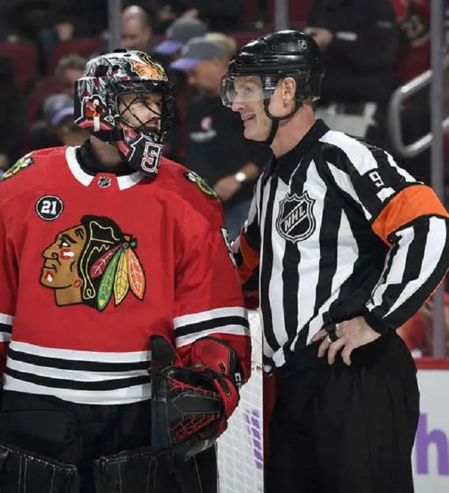 Dan O’Rourke having words with Corey Crawford during a game.