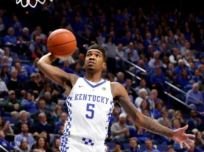 Monk scoring basket during collegiate basketball match in 2018