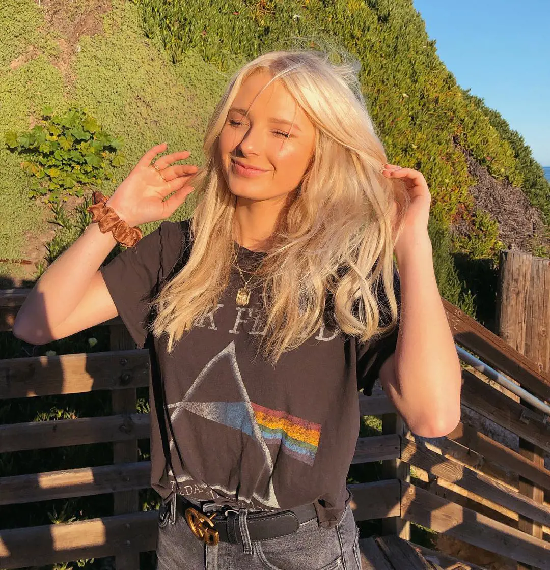 Beautiful looking Kara is seen shutting her eyes in a sun kissed picture with Pink Floyd top in Santa Barbara, California in March 2019