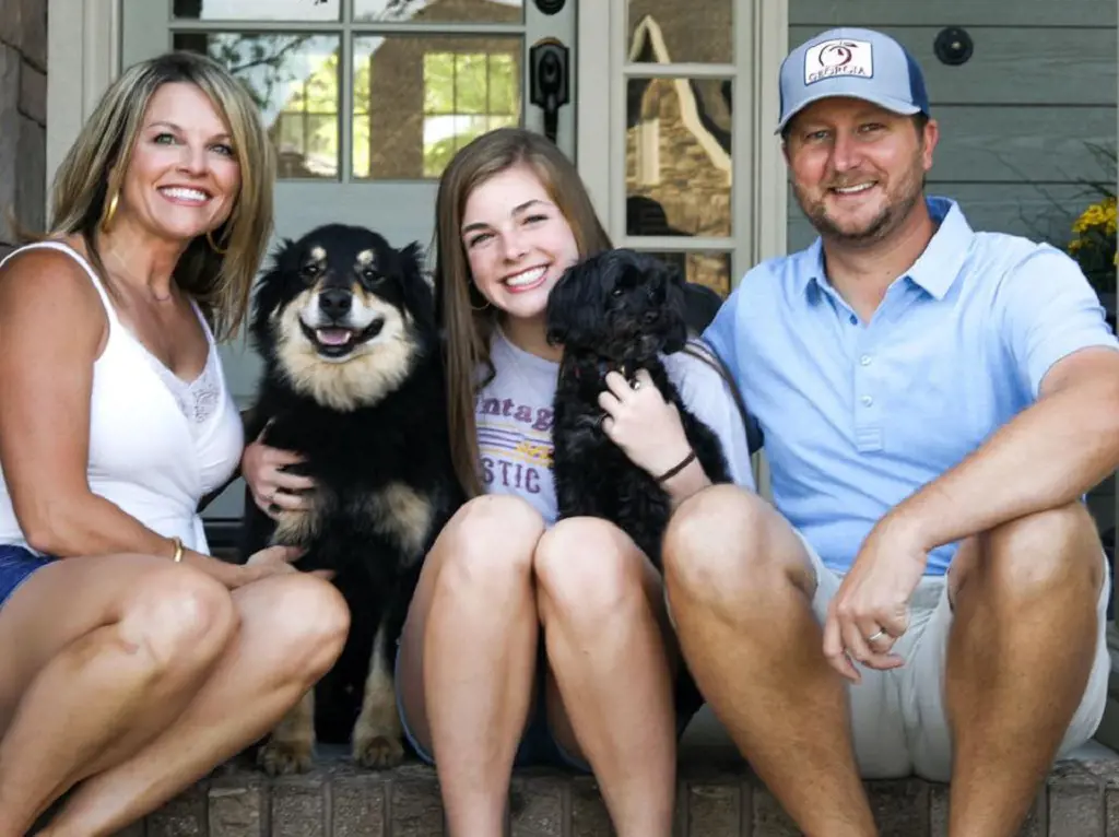 Brice with Suzan and Milly and their two furry friends relaxing outside their front door in April 2020