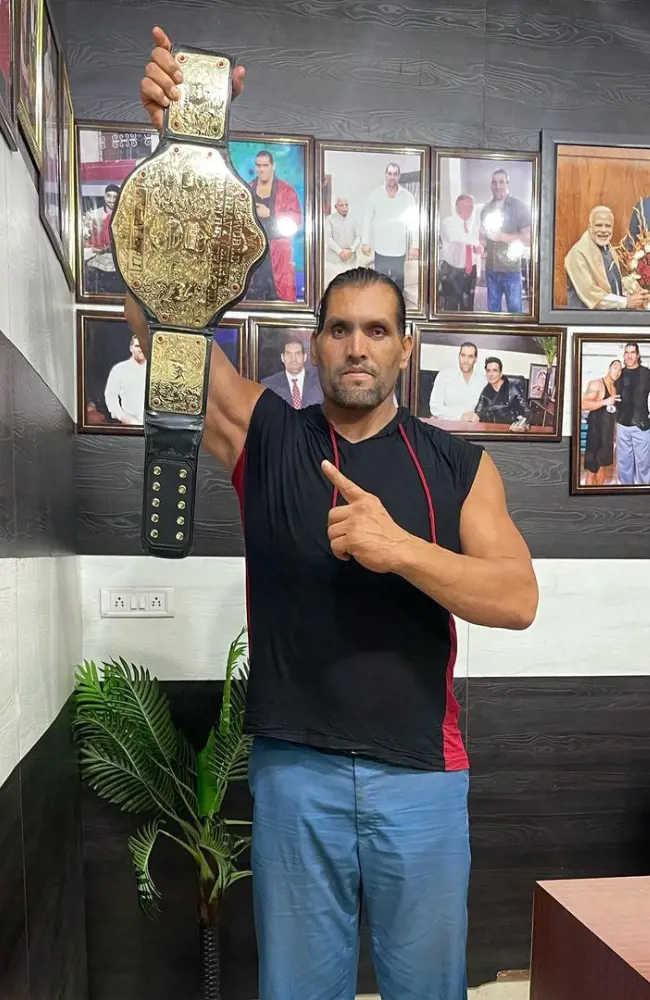 Dalip Singh Rana holding the WWE championship belt in 2022.