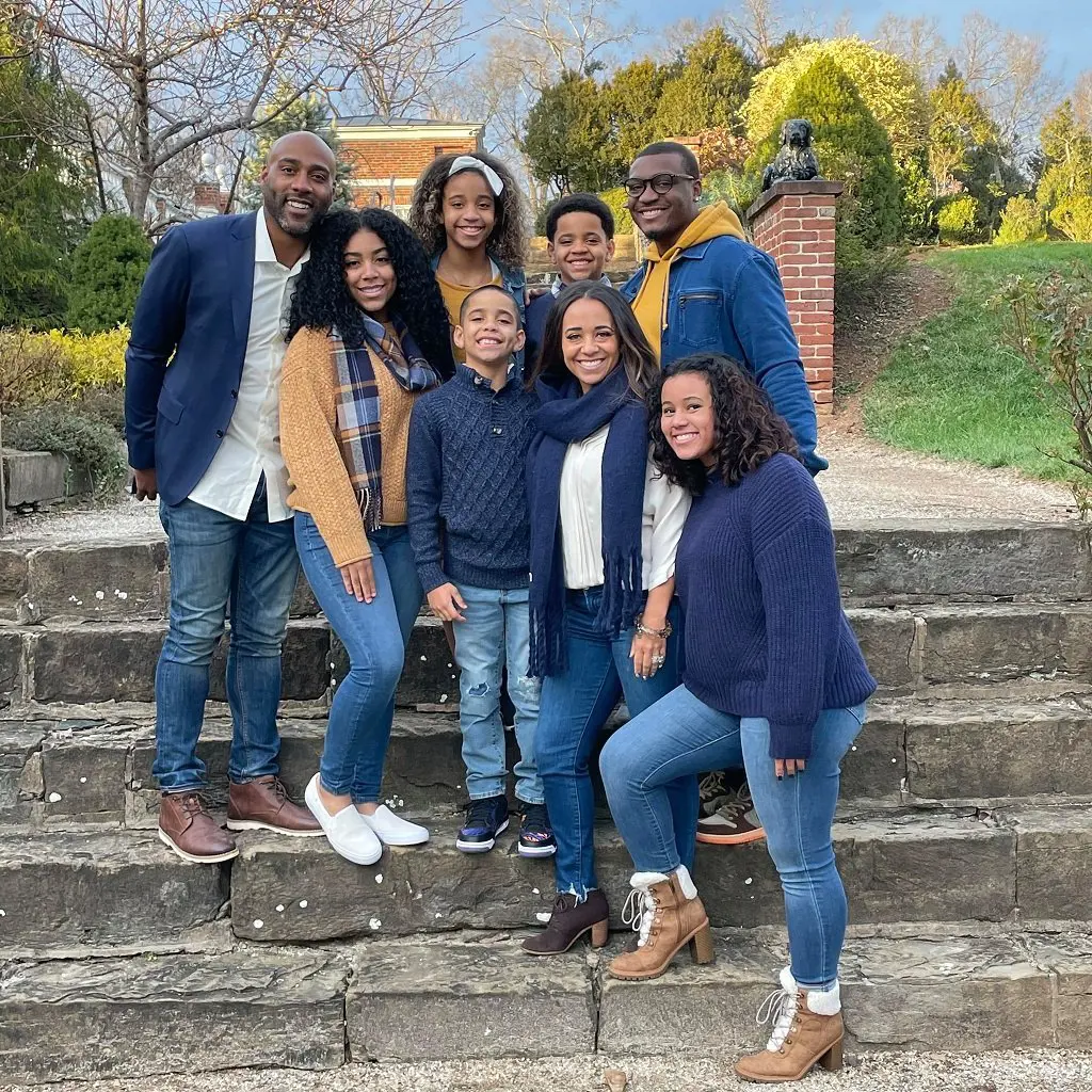 The Halls posing for a portrait while twinning in a matching blue denim attire in April 2021