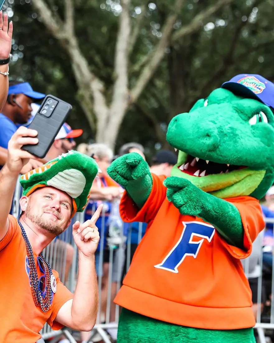 Florids Gators baseball mascot snapping a selfie with a fan in September 2022