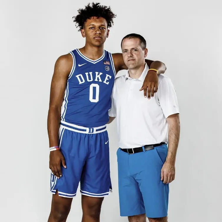 Mario posing with his son during his game.