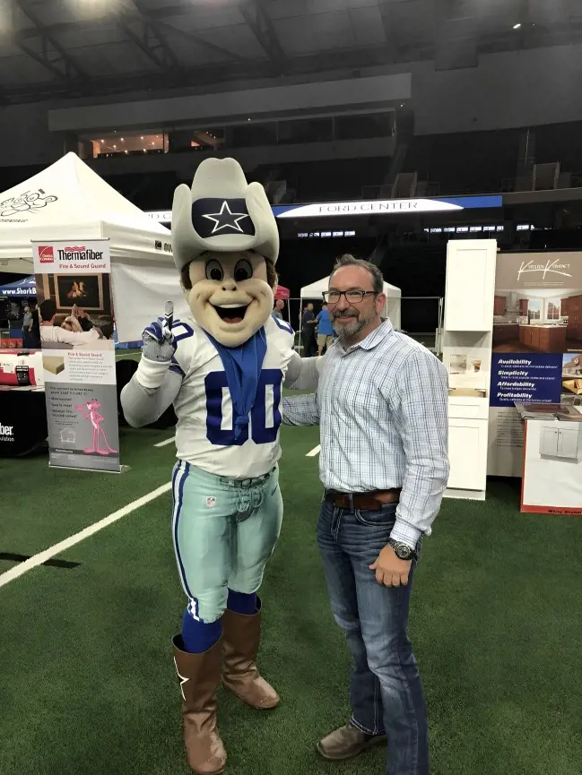 A fan clicks a picture with Rowdy during an event