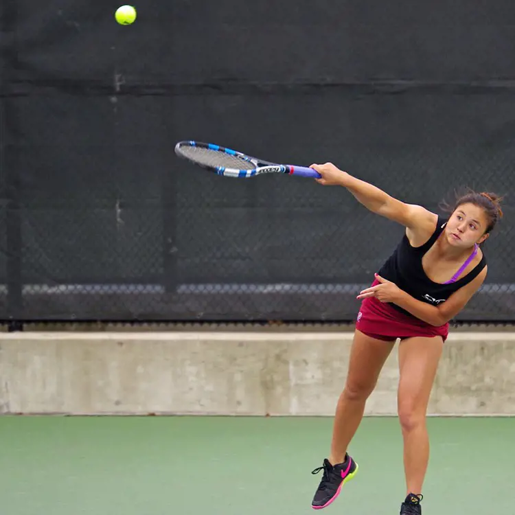 Kana playing tennis for the University of Pennslyvania.