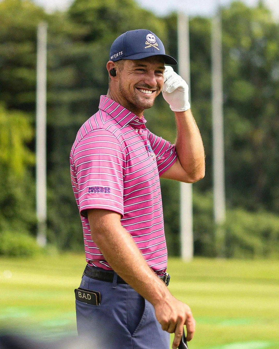 Bryson puts on a wry smile during a golf event in May 2023