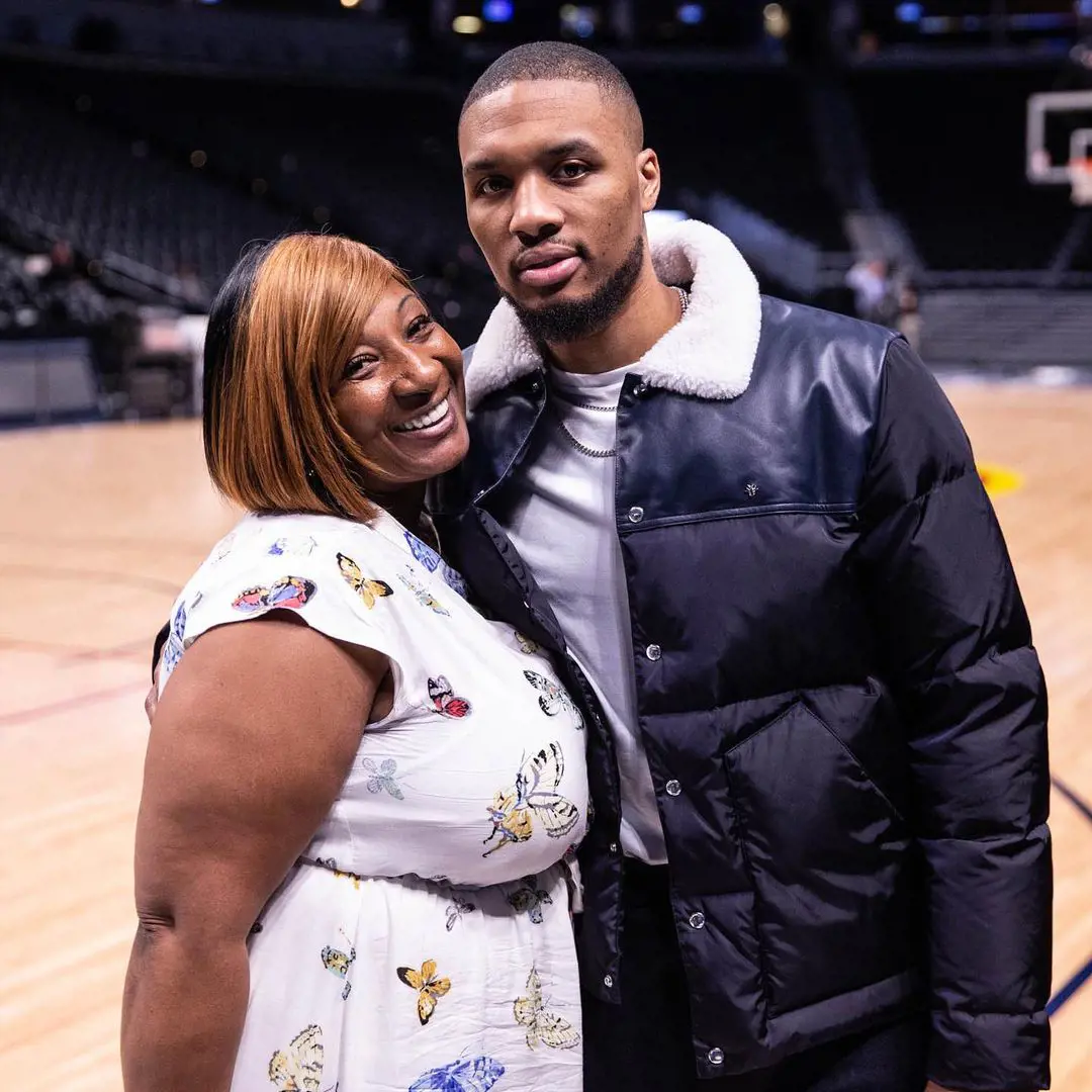 Damian and Gin standing at a basketball court in August 2019