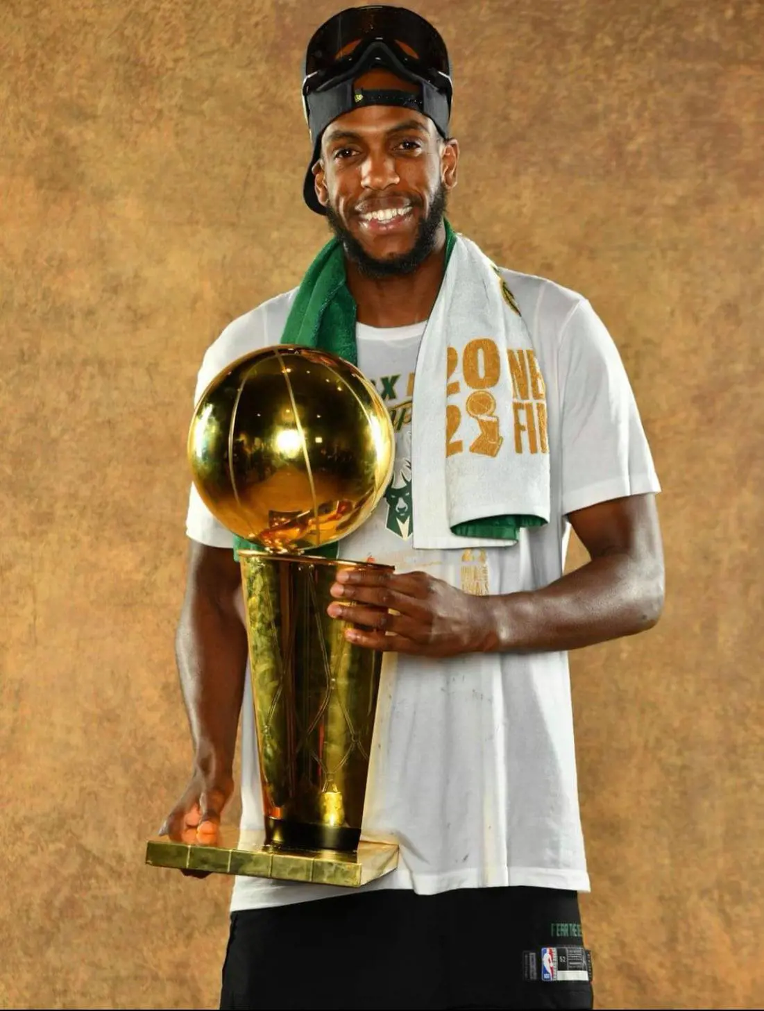 Khris holding the championship. 