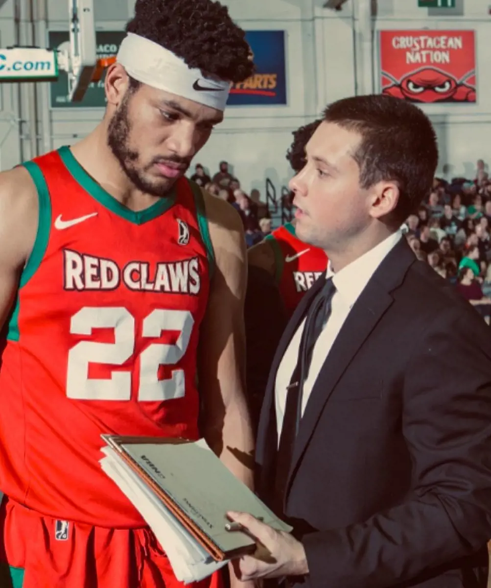 Craig Luschenat (R) giving advice to a Red Claws player in March 2020