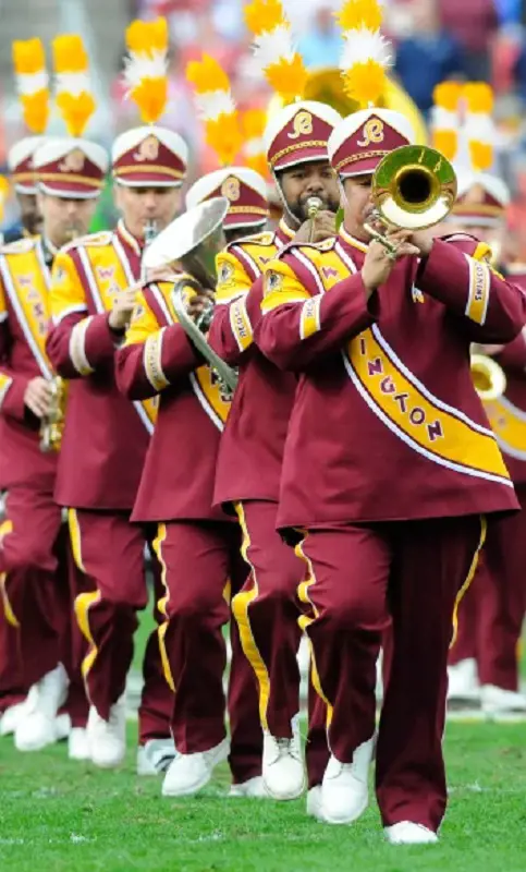 Washington Commanders Marching Band plays and marches on field.