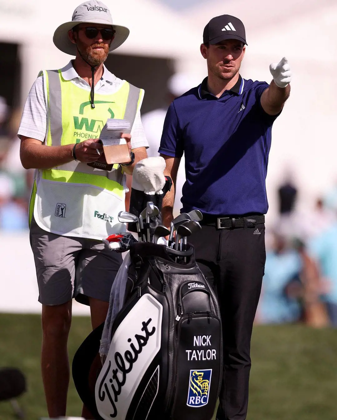 Merkle helping Taylor during the WM Phoenix Open in February 2023