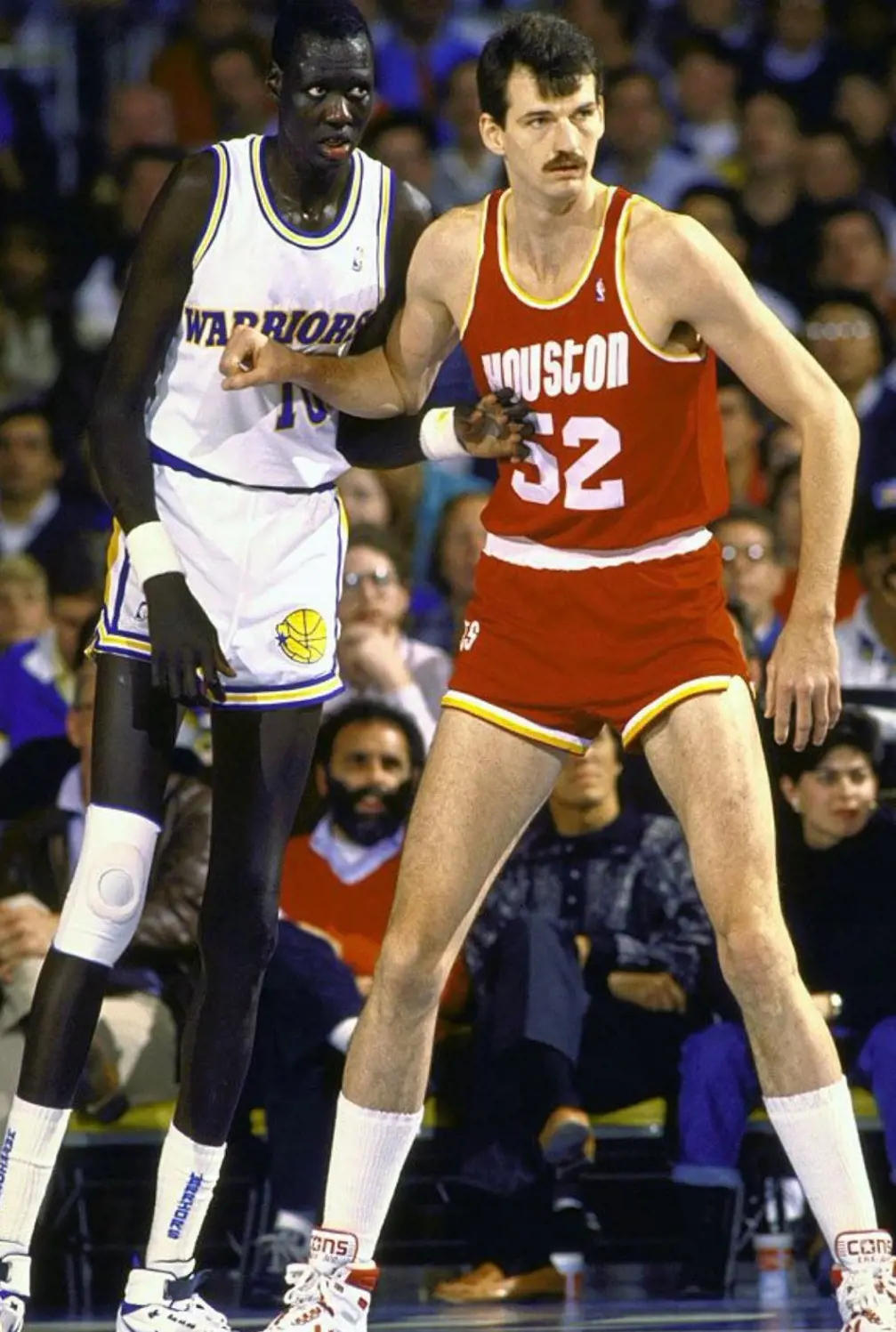 Chuck Nevitt and Manute Bol had similar heights with a difference of 2 inches.