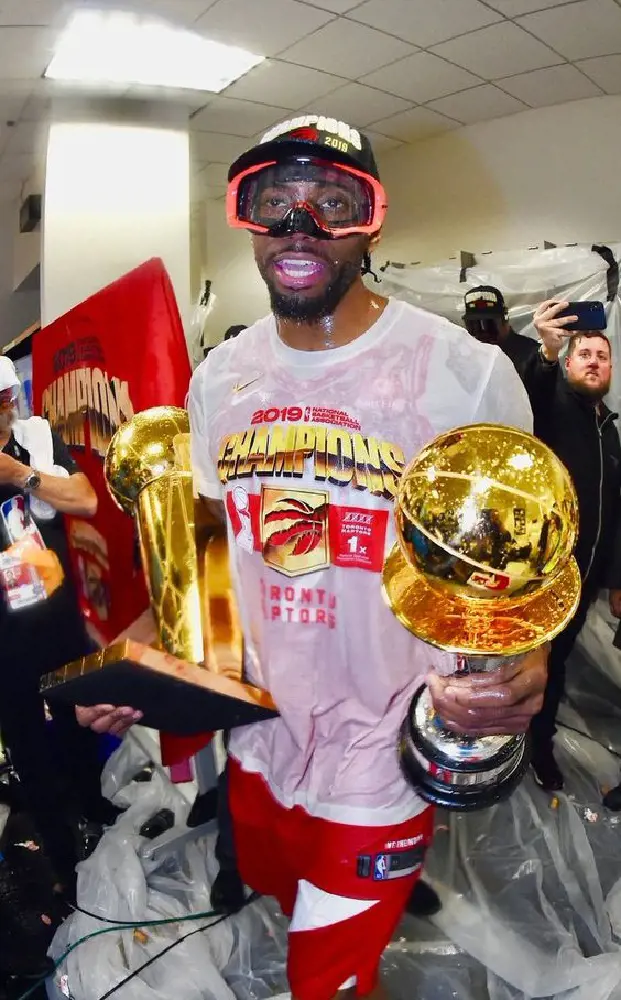 Raptors guard Kawhi Leonard with the NBA trophy and MVP award in 2019