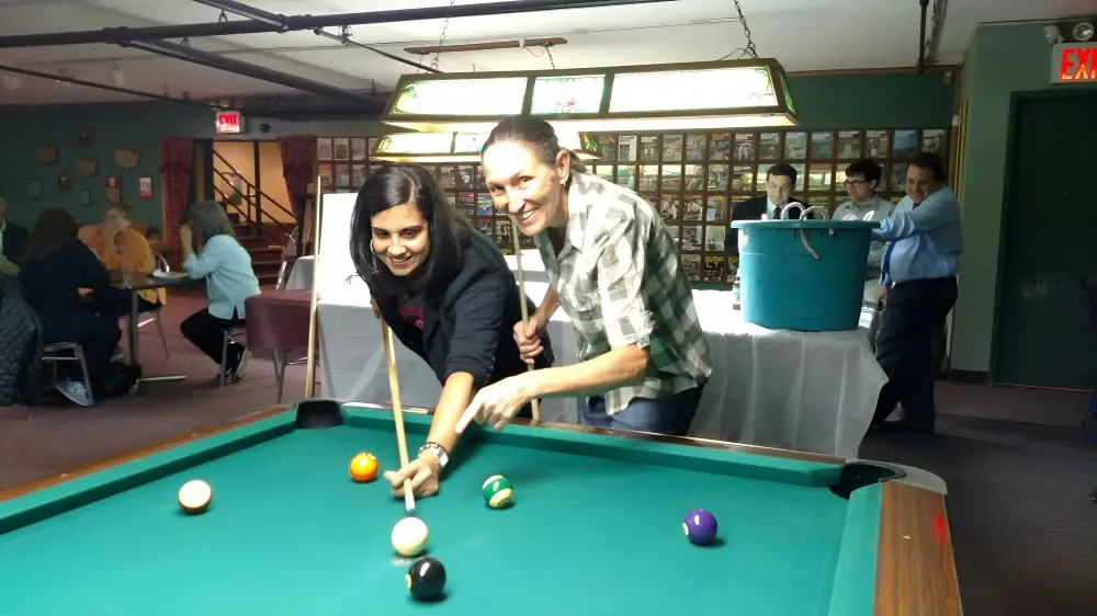 Jean(right) training pool game to U.S. Congress member for Brooklyn, Nicole Malliotakis. 