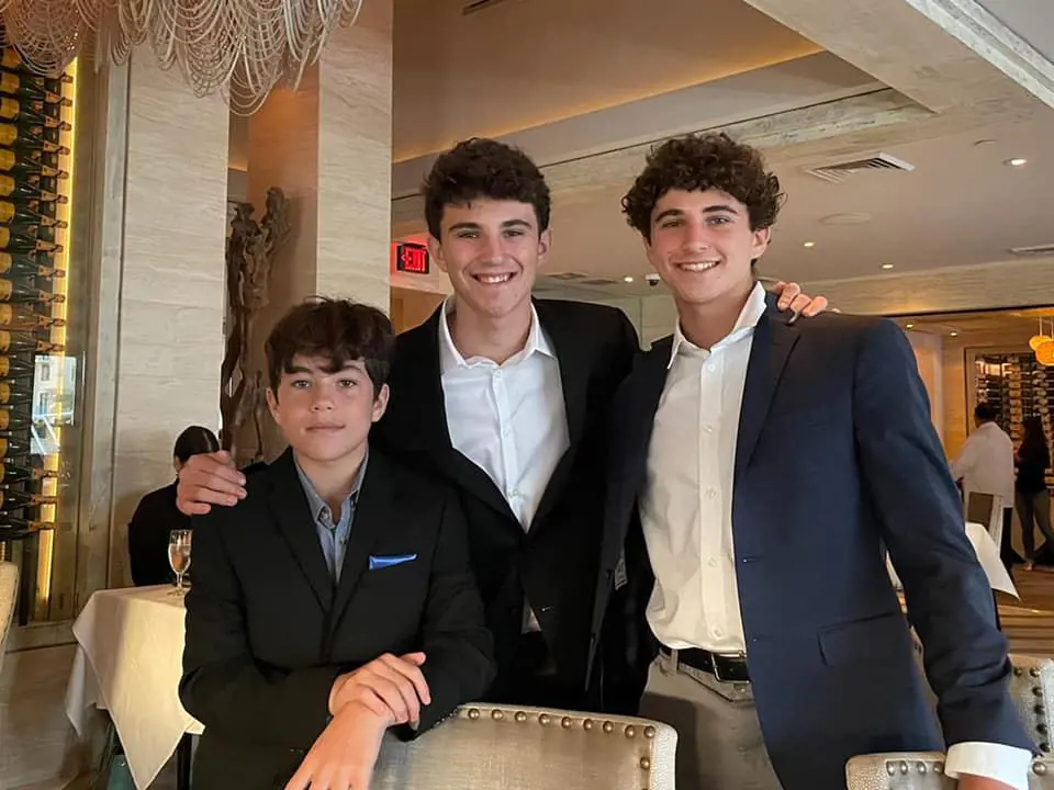 Zachary (center) with Noah (right) and Gabriel (left) at an event in California.