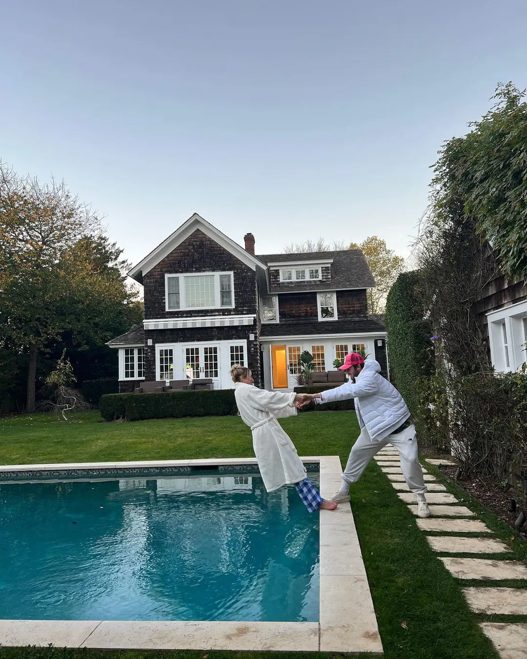 Tommy and Paige spend their time at a swimming pool in Southampton, New York.