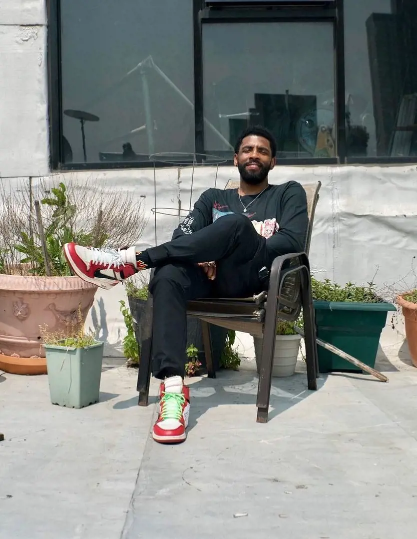 Irving chilling in January 2021, sitting on a chair wearing Nike sneakers