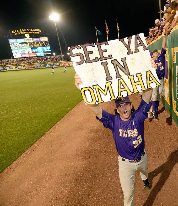 Outfielder Dylan Crews holds a sign that says, 