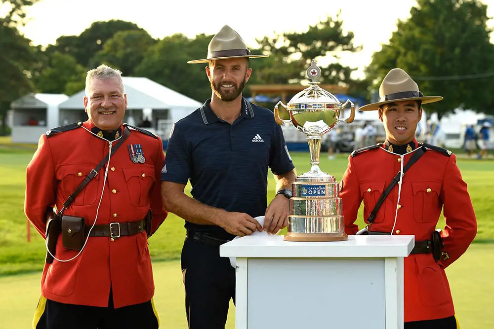 Johnson (middle) posing with the trophy right after his win.