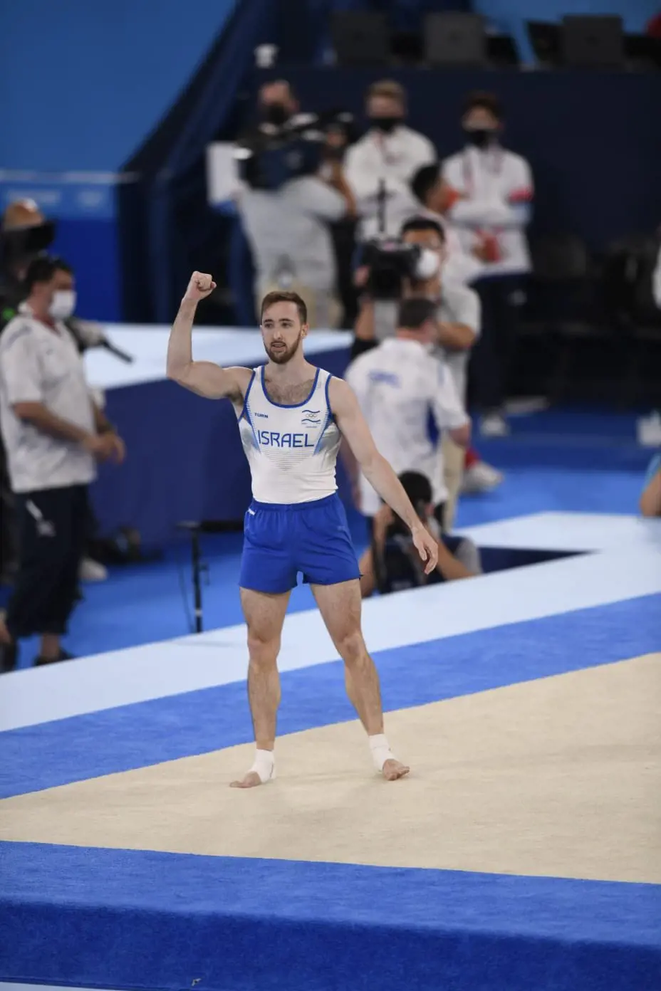 A gymnast from Israel celebrates after completing his floor routine