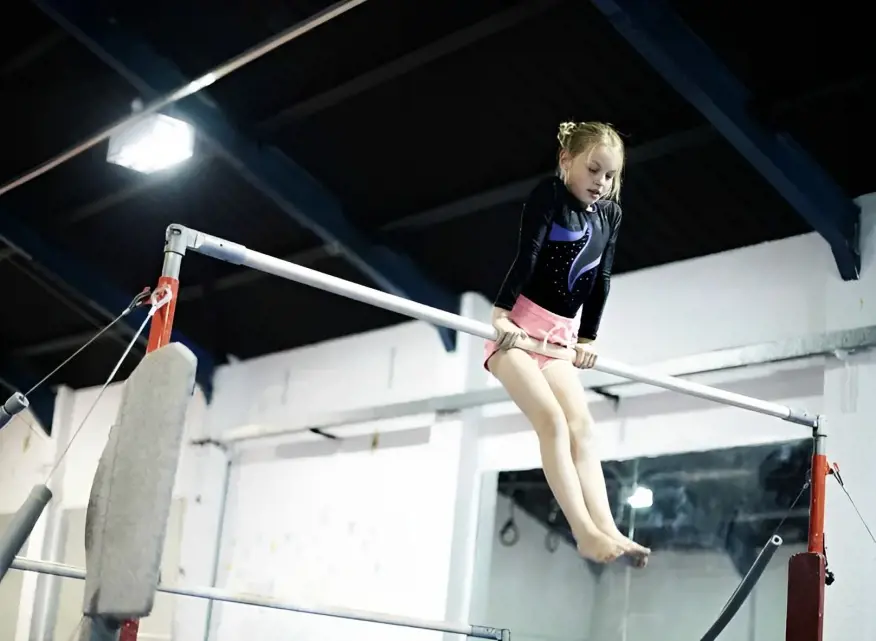 A gymnast performing a move during the bar routine