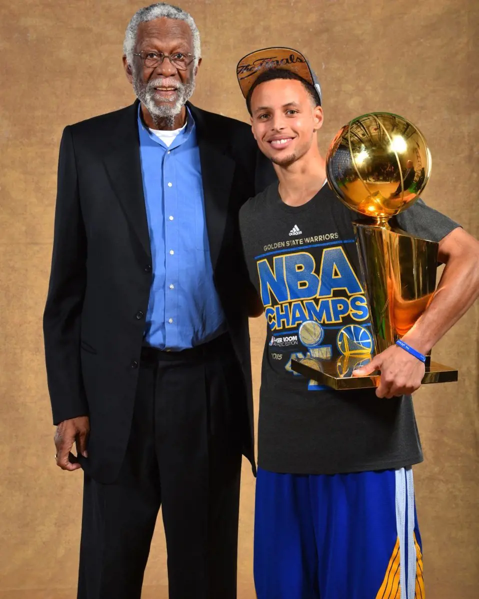 Steph Curry takes a picture with legendary NBA player Bill Russell after the championship win