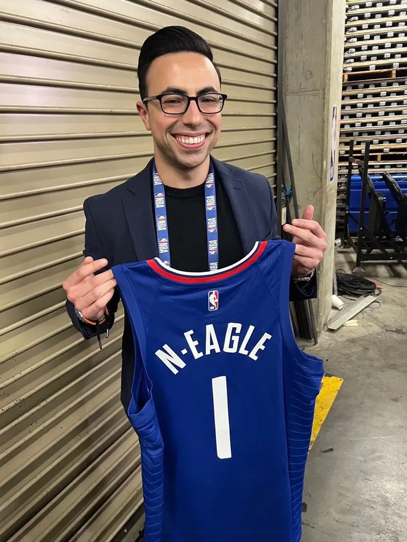 Noah holding the special jersery with his name printed. 