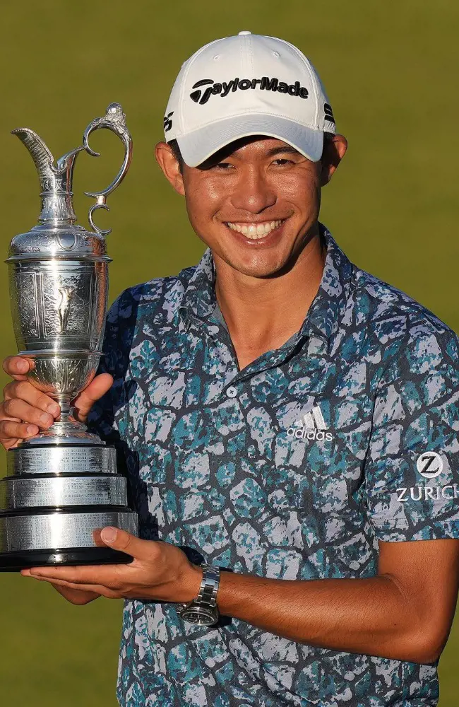 Collin holding champion golfer of the Year Trophy at Royal St George's Golf Club.