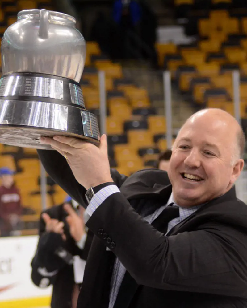 Ted celebrating with the Beanpot after Harvard's win in 2017.