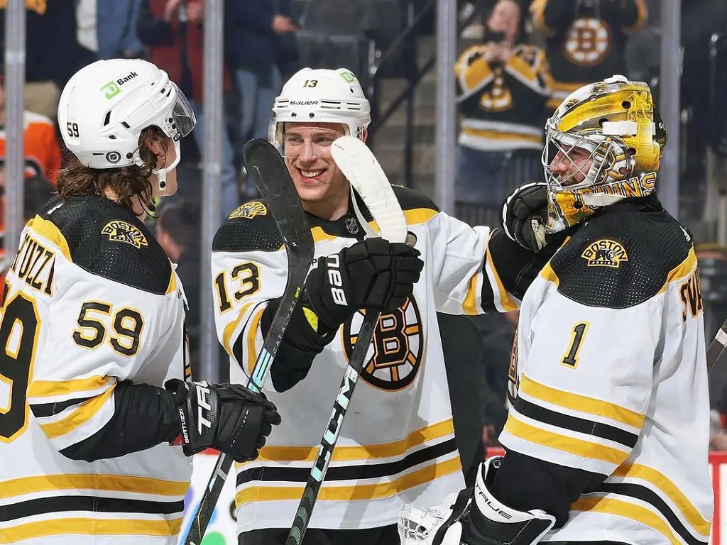 Bruins players Charlie Coyle (M) and Jeremy Swayman (R) celebrates against Flyers after scoring in April 2023