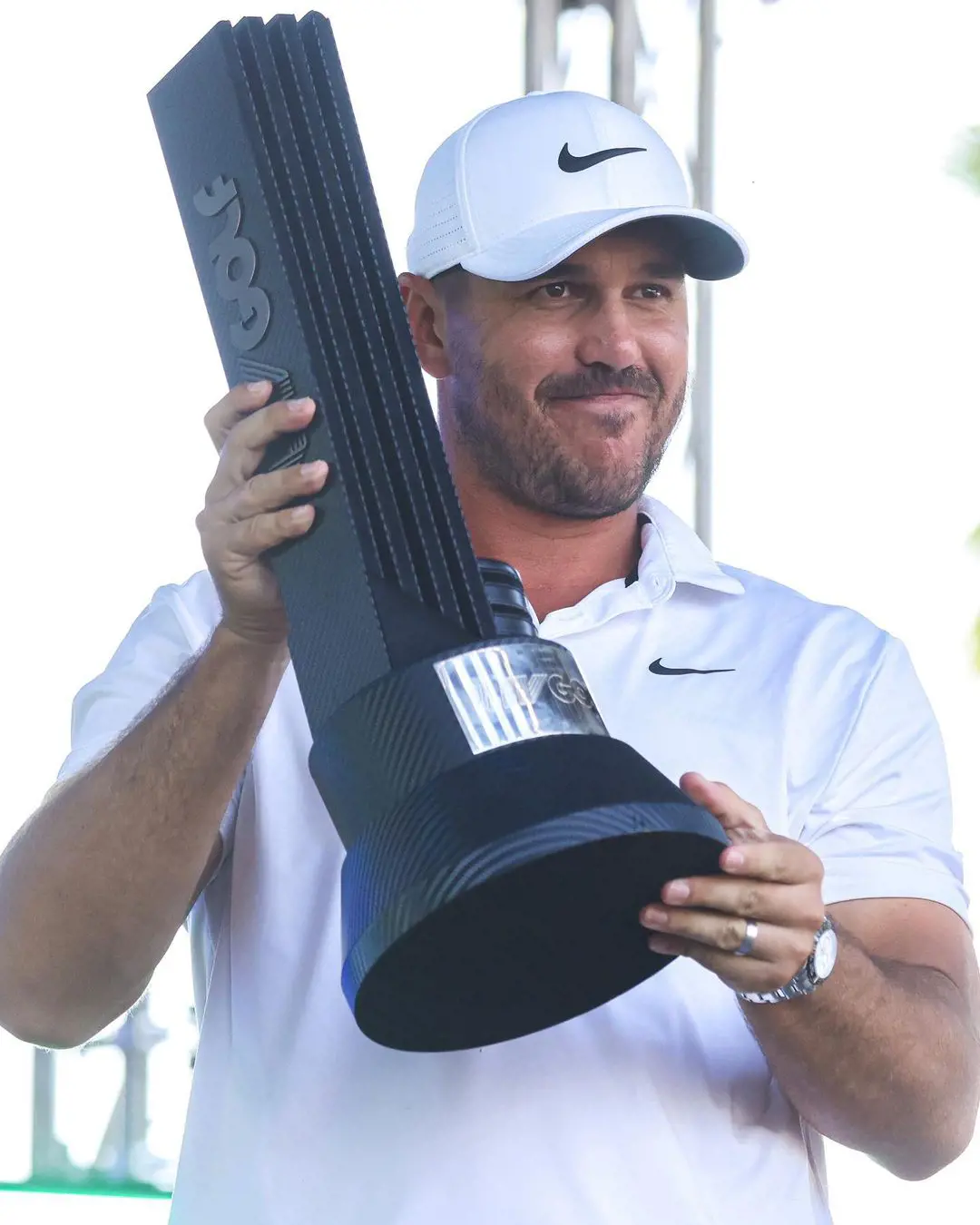 Brooks Koepka lifts LIV Golf League trophy in April 2023 