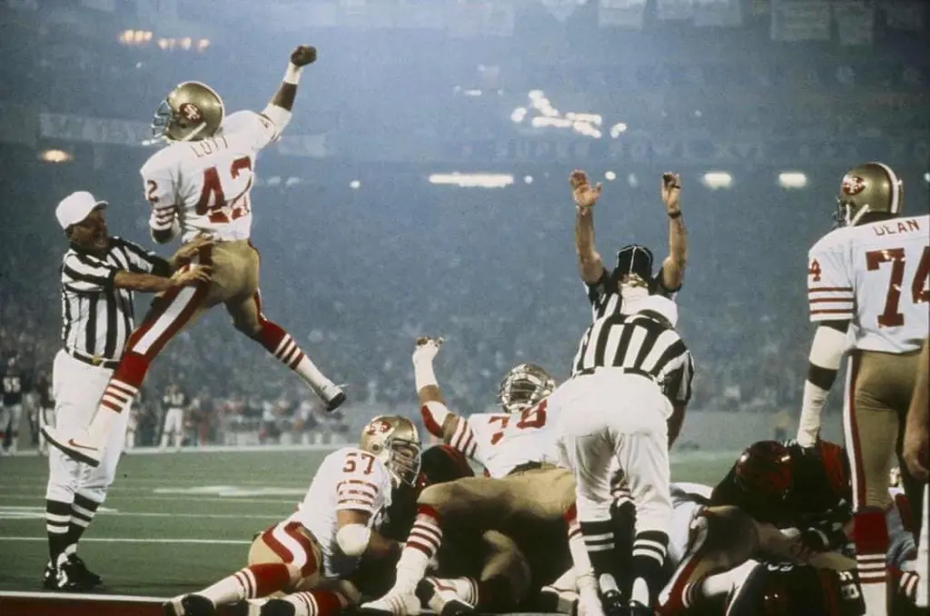 The 1982 49ers roster celebrating their Super Bowl on the field.