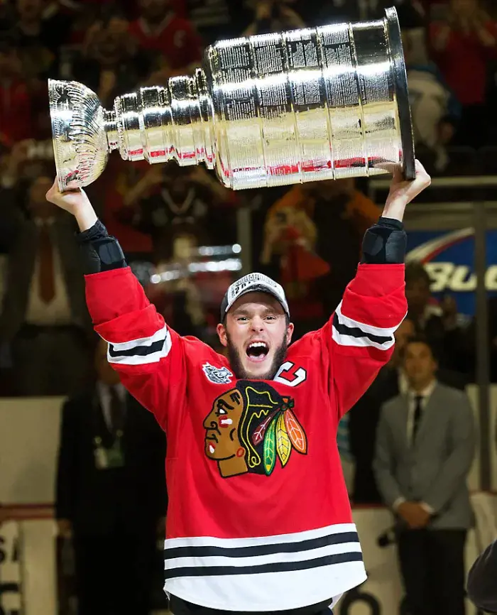 Skipper Jonathan Toews roars while lifting the trophy.