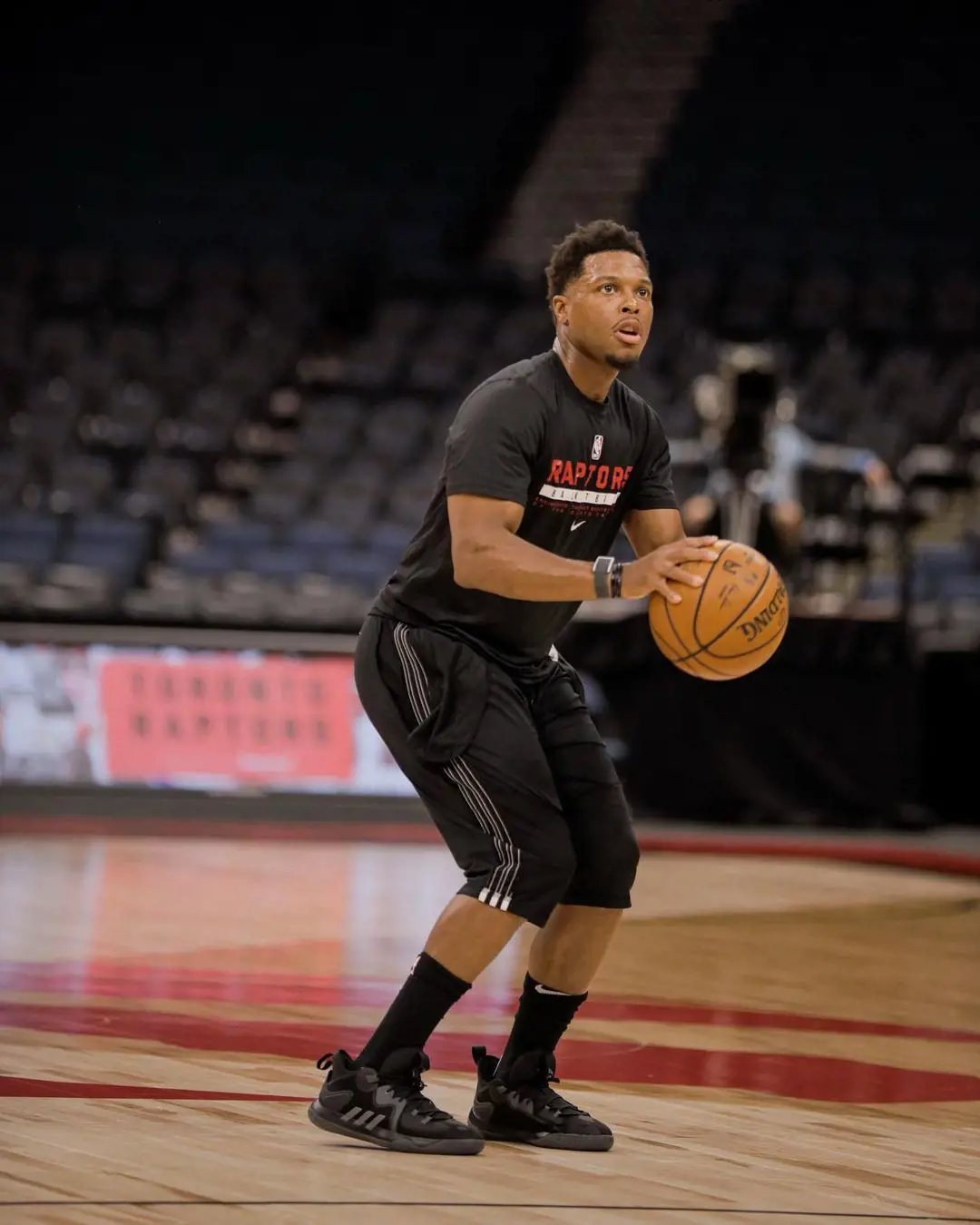 Kyle at the basketball field wearing Raptor printed t-shirt. 