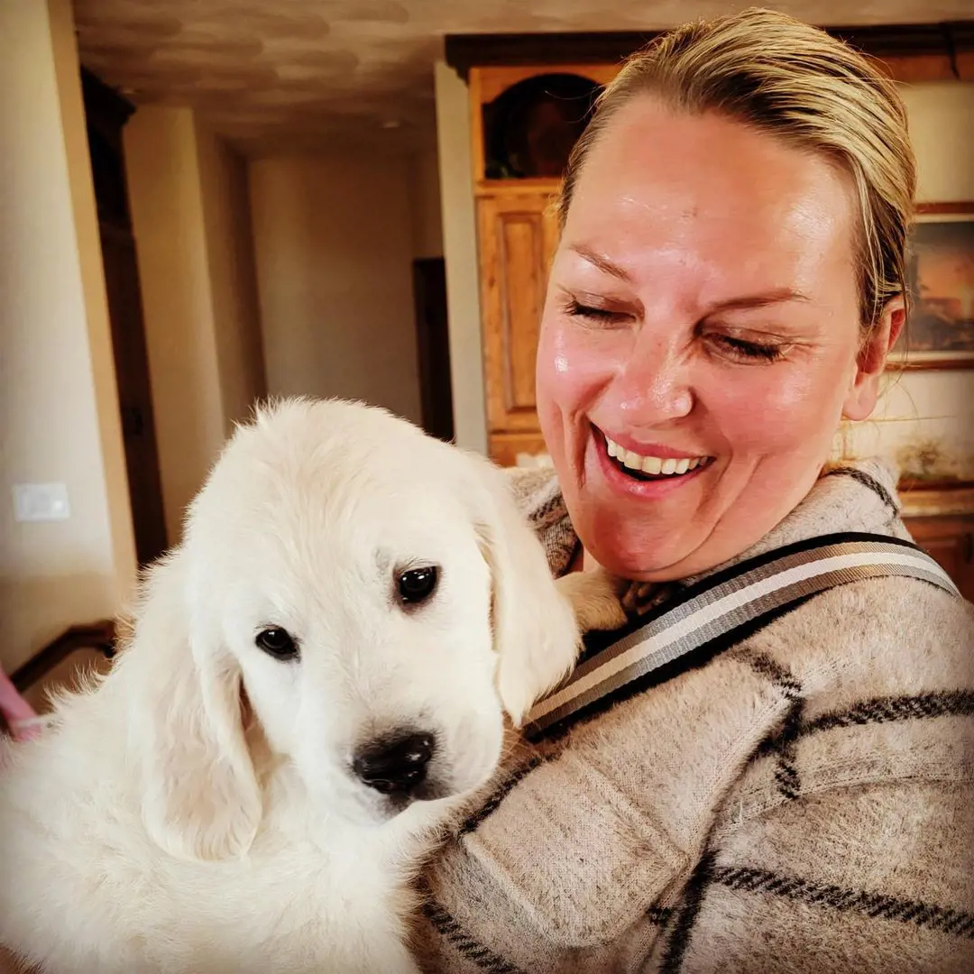 Kelly puts on a grin smile with the family dog named Otto.